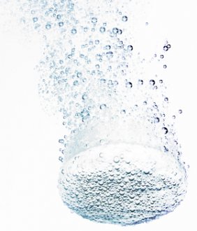 Chlorine tablet in water with bubbles